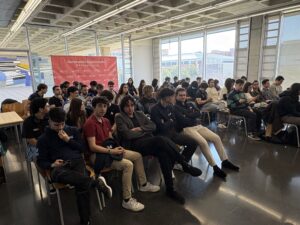 Students from the Generación Espontánea groups seated in the Ximo Mora room during the meeting, with the programme's banner behind them