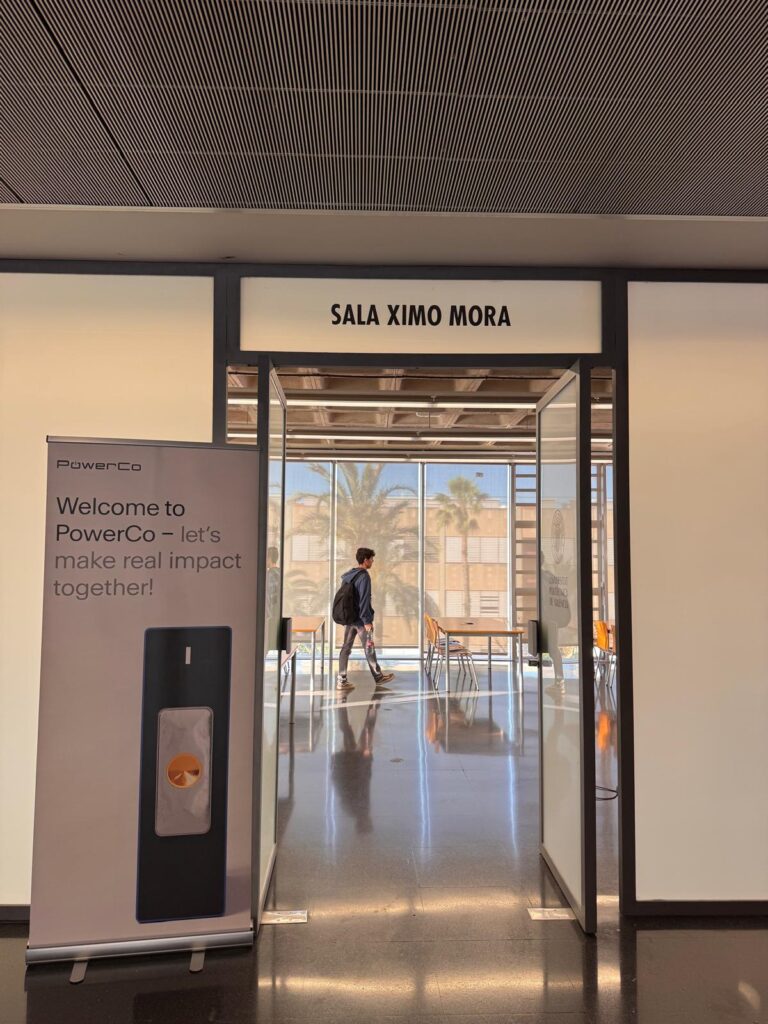 Entrance to the Ximo Mora room with a PowerCo roll-up banner welcoming participants to the hackathon